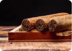 Cigars resting on a wooden box